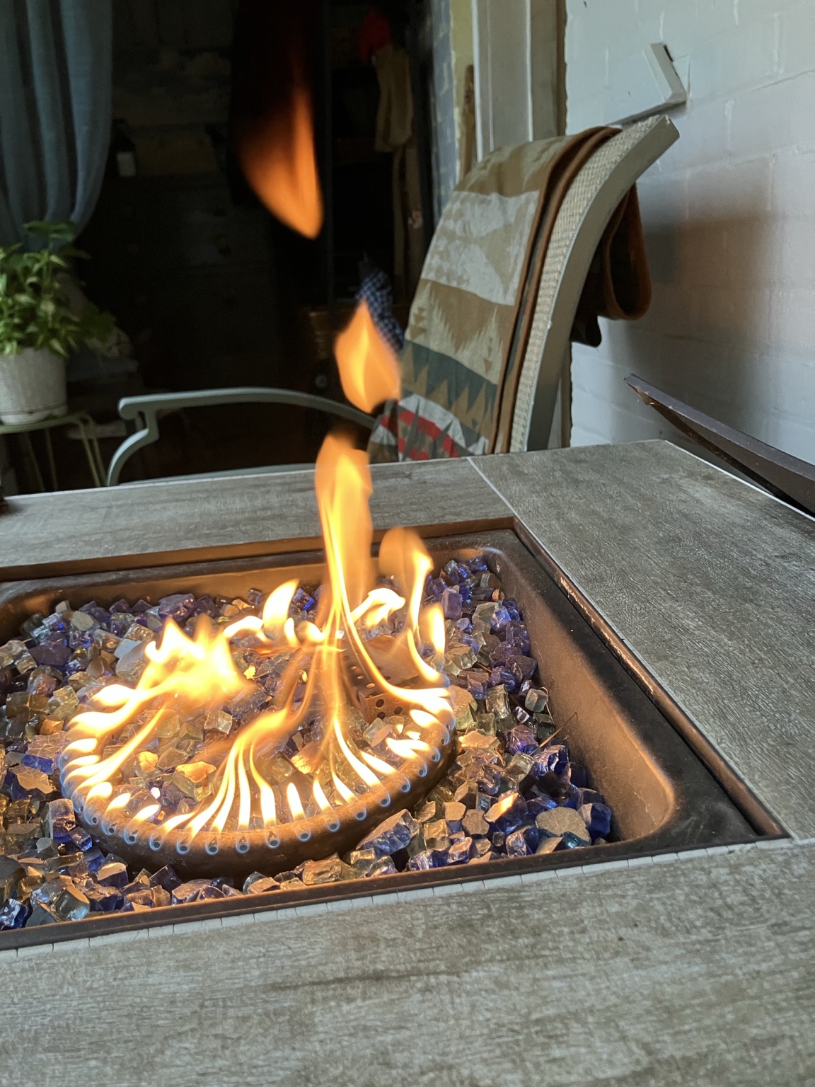 A fire table with flames dancing on glass